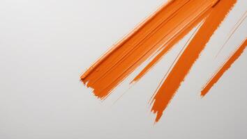 Orange brushstroke with distinct horizontal lines and textured edges. photo