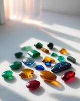 Colorful collection of polished stones displayed on a white surface during natural light. photo