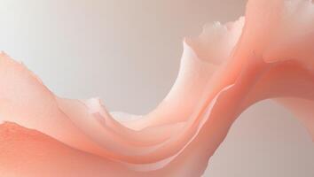 Watercolor brush stroke in soft peach and coral hues creates a delicate and textured abstract shape. photo
