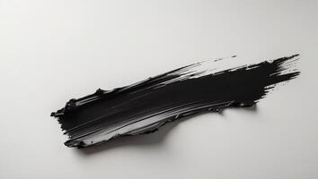 A bold black brushstroke with rough edges creates a dramatic textured effect. photo