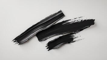 A bold black brushstroke with rough edges creates a dramatic textured effect photo