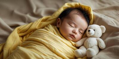 Sleeping Baby Wrapped in Yellow Blanket with White Teddy Bear. photo