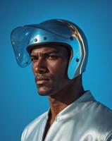 Man wearing a helmet is standing in front of a blue background photo