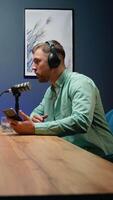 A podcast host speaks into the microphone while sharing insights and engaging in thoughtful discussion during a live recording in a modern studio setting video