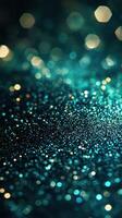 Sparkling turquoise glitter creates a mesmerizing bokeh effect in a softly lit setting during nighttime photo