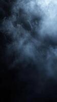 Mysterious wisps of smoke swirl in a dark backdrop creating an atmospheric contrast photo