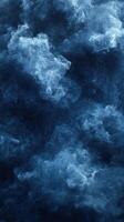 Swirling blue smoke creates an ethereal atmospheric effect in a darkened space photo
