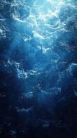 Turbulent ocean water illuminated by sunlight creates a captivating display of blue hues and frothy waves photo