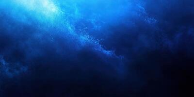 Vivid blue ocean waves crashing under moonlight at night in a tranquil setting photo