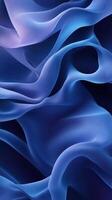 Flowing blue silk fabric drapes elegantly in soft, undulating waves creating a serene and calming atmosphere photo