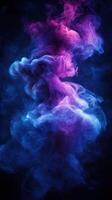 Colorful smoke in shades of pink and blue swirling against a dark background creates an abstract visual effect photo