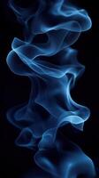 Abstract blue smoke formation creates a captivating visual in a dark background photo