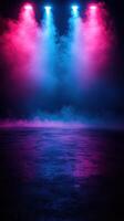 Colorful stage lights illuminate a misty performance area in a dramatic setting for an upcoming event or show photo