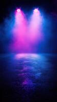 Vibrant stage lighting with pink and blue hues illuminating a reflective wet surface during a concert or performance photo