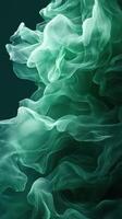Ethereal green fabric swirling gracefully in a dark background illuminated by soft light photo