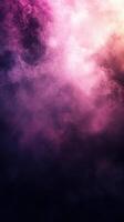 Colorful smoke swirls blend together in an abstract display of purple and pink hues during a serene moment photo