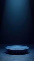 Stage illuminated by a single light beam in a dark, minimalistic space creating an atmospheric setup for performances photo