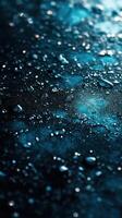 Surfaces glisten with droplets reflecting soft blue light in a dark atmospheric setting photo