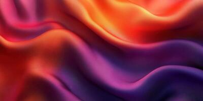 Colorful fabric waves flowing smoothly in vibrant shades of orange, red, and purple photo