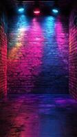 Colorful lighting illuminates a textured brick wall in a dark room creating an atmospheric setting for events or performances photo