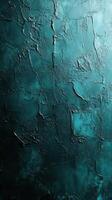 Rich textured wall with deep teal hues showcasing artistic plasterwork and intriguing surface patterns in varied lighting photo
