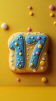 Colorful 17 birthday cake design featuring bright icing and sprinkles on a yellow background for a festive celebration photo