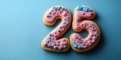 Celebration cookies designed as the number twenty-five with colorful frosting on a blue background photo