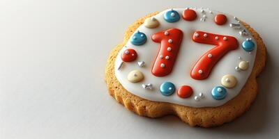 Celebratory cookie decorated for a 17th birthday party with colorful icing and sprinkles photo