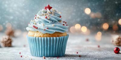 Delicious blue frosted cupcake with festive decorations on a winter background photo