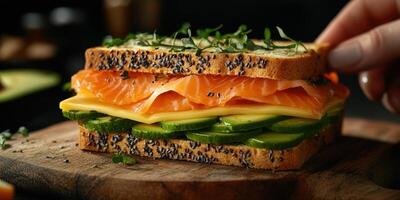 Sandwich with smoked salmon, cucumber, and cheese being prepared on a wooden board in a cozy kitchen photo