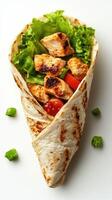 Delicious grilled chicken wrap filled with fresh lettuce and tomatoes served on a clean white background photo