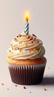 Delightful cupcake with cream frosting and a lit candle for celebration photo