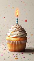 Delicious cupcake with a lit candle surrounded by colorful confetti for a festive celebration photo