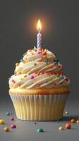 Colorful cupcake with a lit candle and sprinkles adorned for a festive celebration moment photo