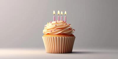 Colorful cupcake with pink frosting and candles celebrating a birthday on a simple background photo