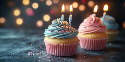 Delicious cupcakes with blue and pink frosting and candles on a festive table during a birthday celebration photo