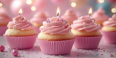 Delicious pink frosted cupcakes with candles and sprinkles for a festive celebration in a brightly lit setting photo