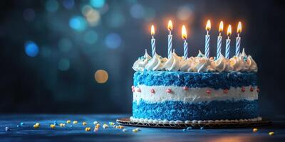 Celebrate a joyful birthday with a decorated blue cake topped with candles set against a festive dark background photo