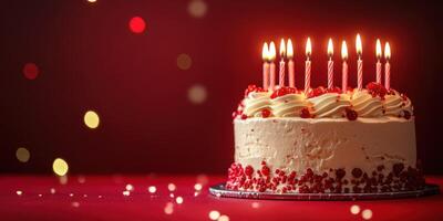 Celebration of birthday with a decorated cake featuring candles and red accents in a festive atmosphere photo