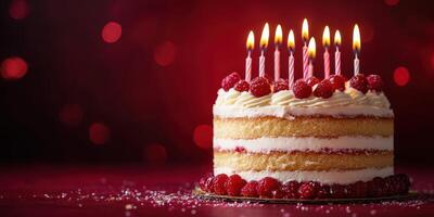 Birthday cake with lit candles and raspberries set against a bokeh background in a festive celebration atmosphere photo