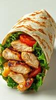 Grilled chicken wrap with fresh vegetables in a soft tortilla served on a clean surface photo