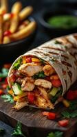 Delicious chicken fajita wrap with fresh vegetables and fries served on a wooden board photo