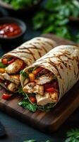 Delicious grilled chicken wraps filled with fresh vegetables served on a wooden board photo