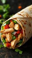 Freshly made chicken burrito wrapped in a warm tortilla with colorful vegetables and herbs photo