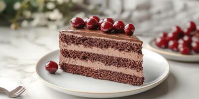 Dessert featuring a luscious chocolate cake layered with rich mousse and topped with cherries on a marble countertop photo