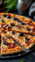 Slices of delicious pepperoni and olive pizza served on a rustic table photo