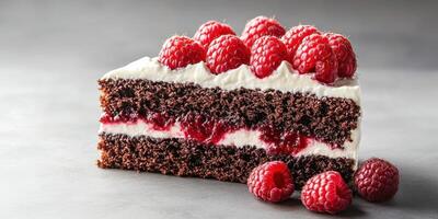 Delicious chocolate raspberry cake garnished with fresh raspberries on a gray background photo