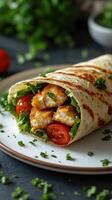 Delicious wrap filled with crispy fish, fresh vegetables, and herbs on a plate photo