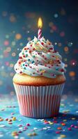 Colorful birthday cupcake with a lit candle and sprinkles on a festive background photo