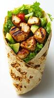 Fresh grilled chicken wrap filled with greens and vegetables ready to be enjoyed for lunch photo